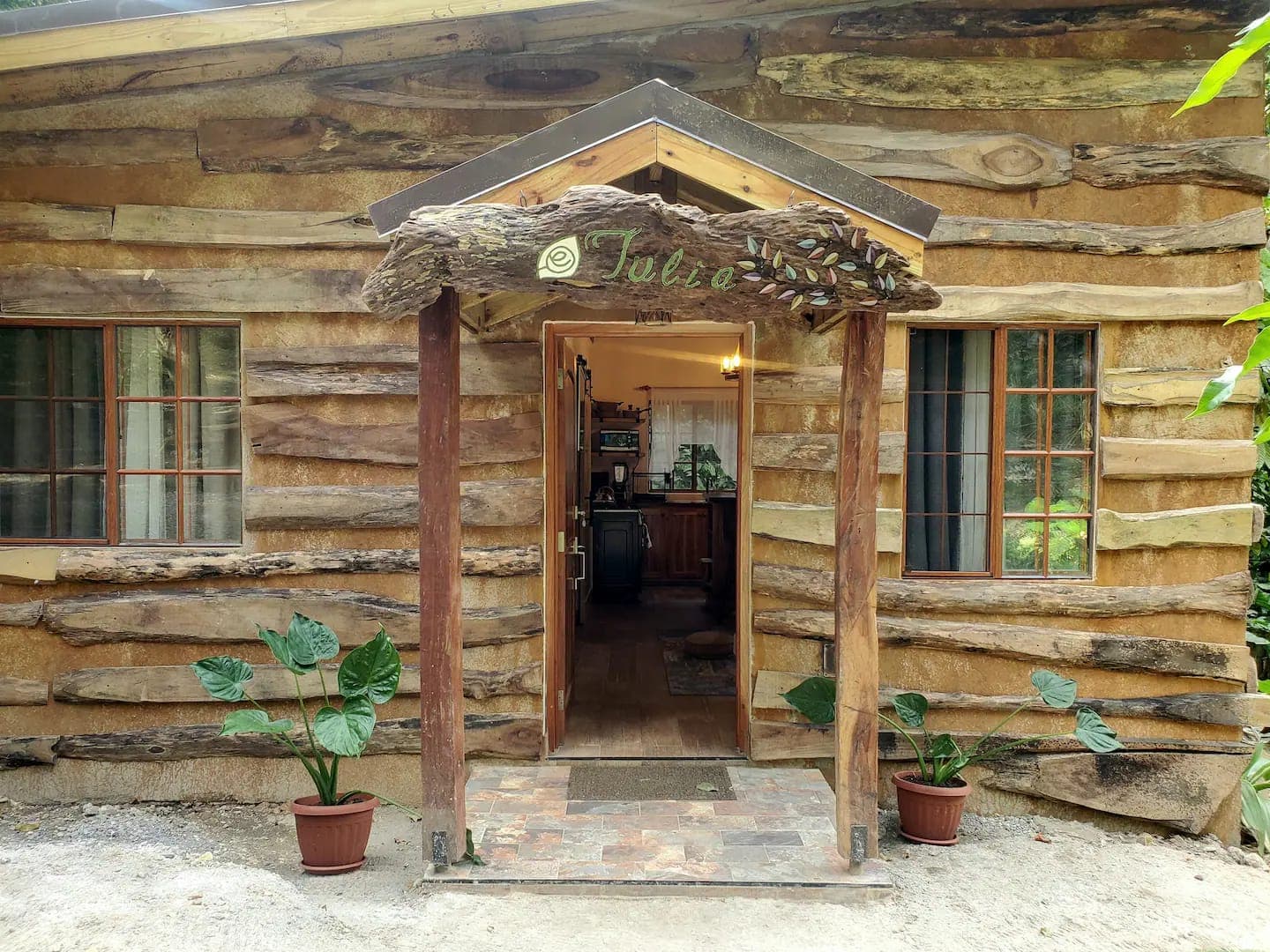 Hand-built Tulia cabin entrance with carved sign